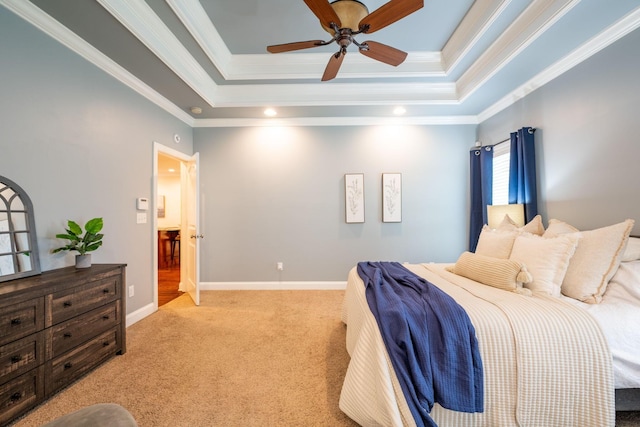 bedroom featuring carpet flooring, a raised ceiling, ornamental molding, ceiling fan, and baseboards