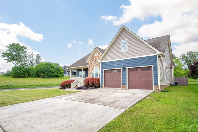 craftsman-style house with driveway, a front yard, and central AC
