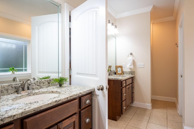 bathroom featuring two vanities, tile patterned flooring, ornamental molding, and baseboards