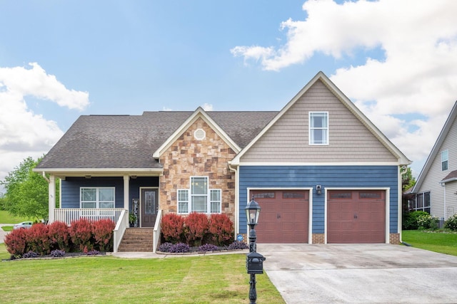 craftsman-style home featuring a front yard, driveway, a porch, an attached garage, and stone siding