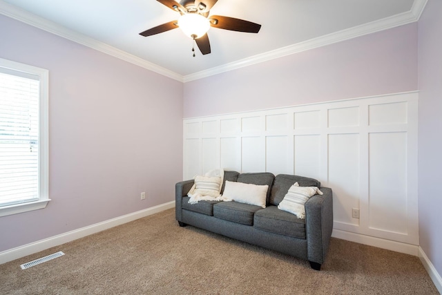 sitting room featuring ornamental molding, carpet floors, a ceiling fan, and baseboards