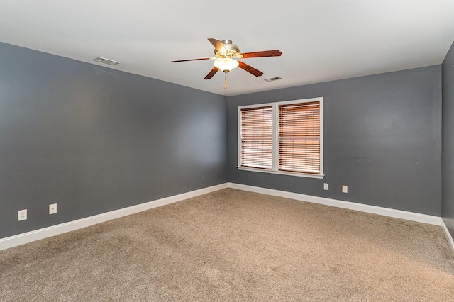 carpeted spare room featuring ceiling fan