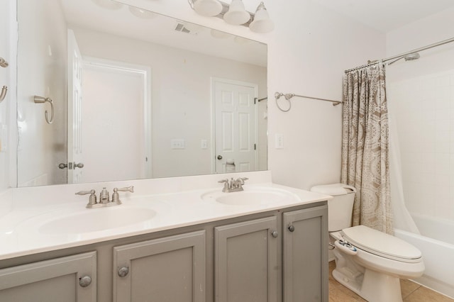 full bathroom featuring vanity, tile patterned flooring, toilet, and shower / bath combo with shower curtain