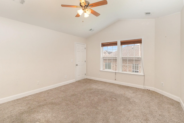 spare room featuring lofted ceiling, ceiling fan, and carpet