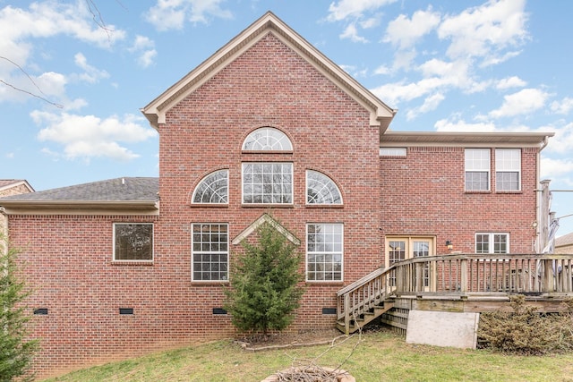 back of house featuring a wooden deck and a lawn