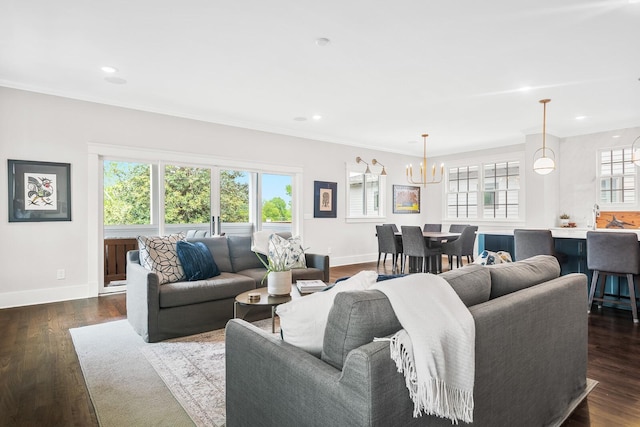 living room featuring crown molding, dark wood-type flooring, and a chandelier