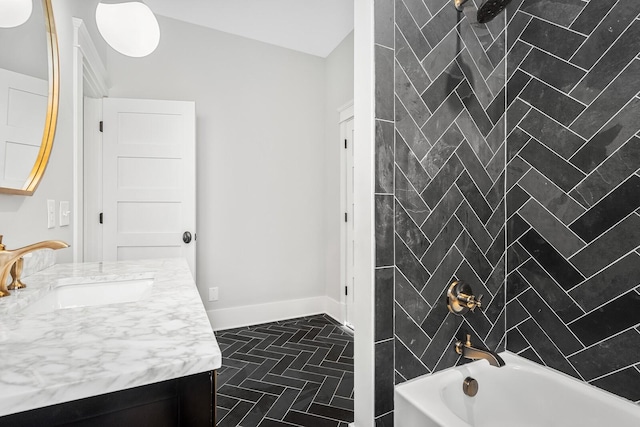 bathroom featuring vanity and tiled shower / bath