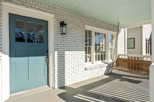 view of exterior entry featuring a porch