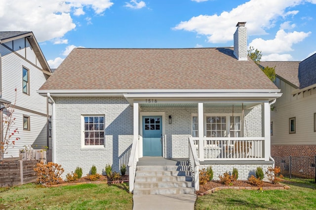 bungalow-style home with a porch and a front yard