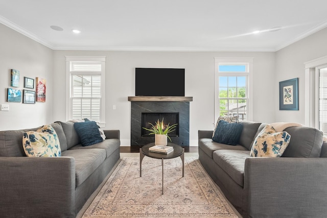 living room featuring hardwood / wood-style floors, a premium fireplace, and crown molding