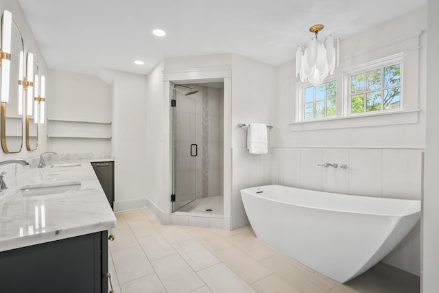 bathroom featuring tile patterned floors, plus walk in shower, vanity, and a notable chandelier