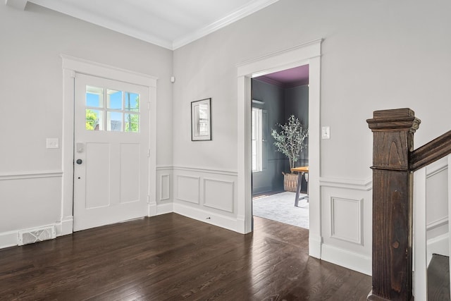 entryway with crown molding and dark wood-type flooring