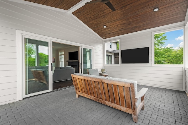 exterior space featuring ceiling fan, lofted ceiling, and wood ceiling