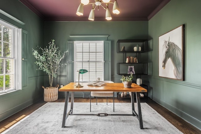 home office featuring a healthy amount of sunlight, dark hardwood / wood-style flooring, ornamental molding, and a chandelier