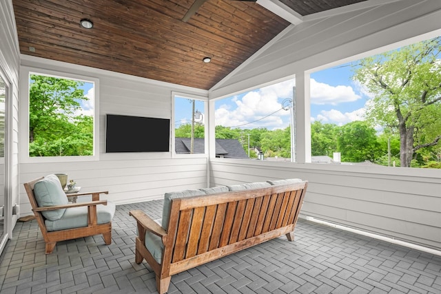 sunroom / solarium featuring plenty of natural light, wooden ceiling, and vaulted ceiling