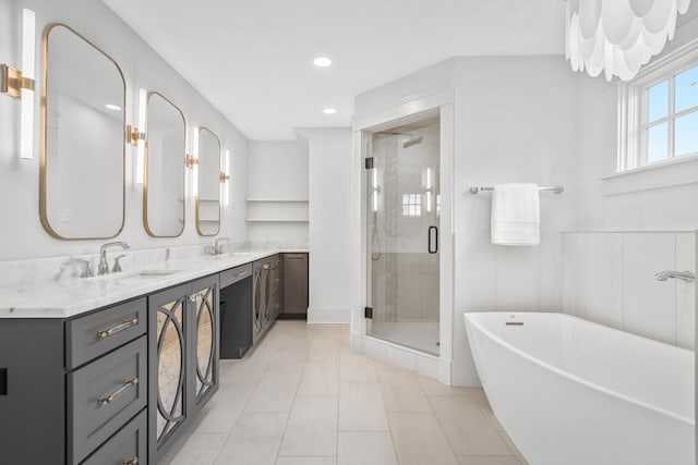 bathroom featuring plus walk in shower, vanity, and tile patterned flooring