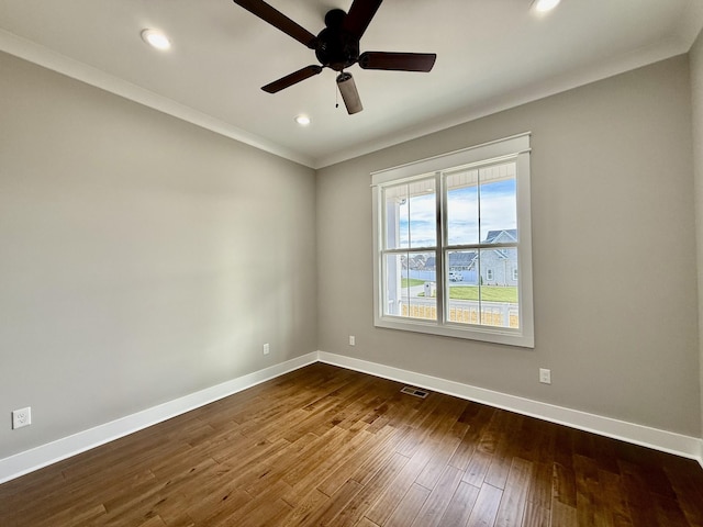 unfurnished room featuring ceiling fan, ornamental molding, and dark wood-type flooring