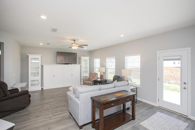 living room featuring light hardwood / wood-style flooring, plenty of natural light, and ceiling fan