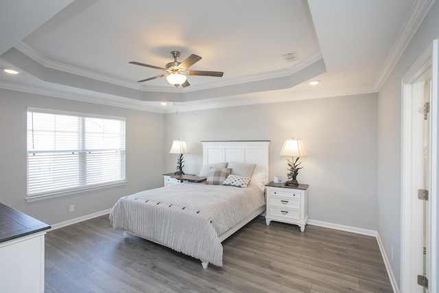 bedroom with ceiling fan, dark hardwood / wood-style floors, a raised ceiling, and ornamental molding