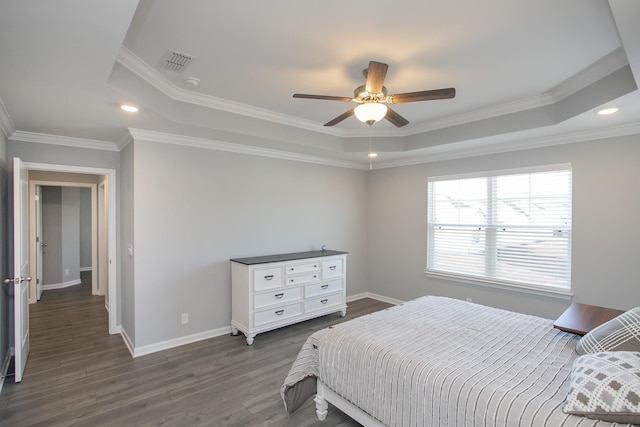 bedroom featuring dark hardwood / wood-style floors, ceiling fan, a raised ceiling, and crown molding