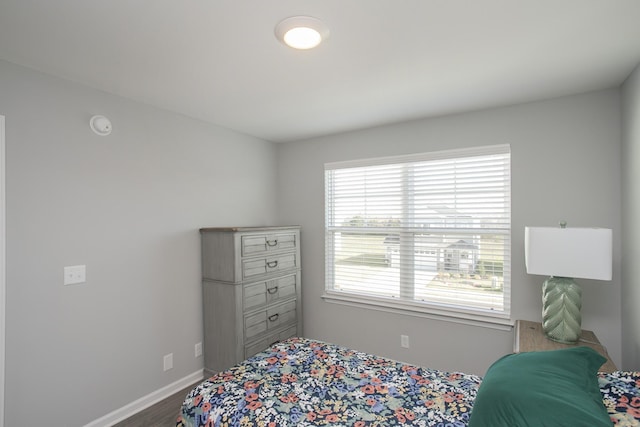 bedroom with hardwood / wood-style flooring