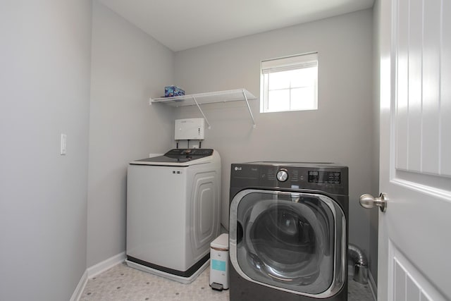 clothes washing area with separate washer and dryer