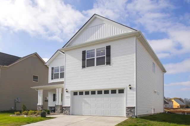 front facade with a front lawn and a garage