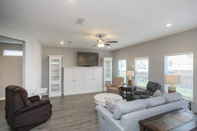 living room with wood-type flooring and ceiling fan