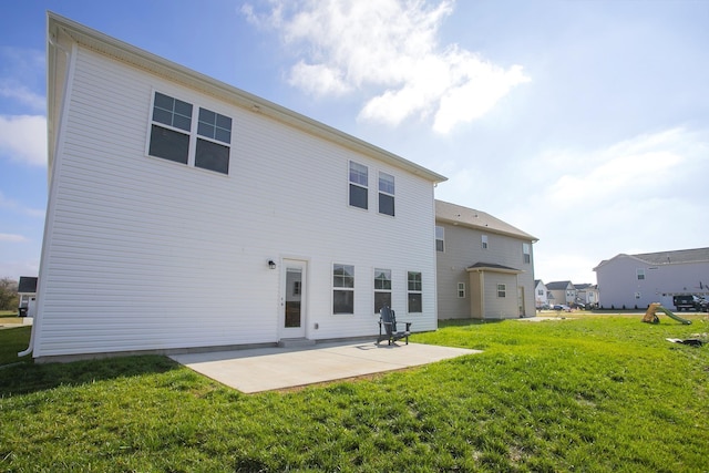 back of property featuring a patio area and a yard