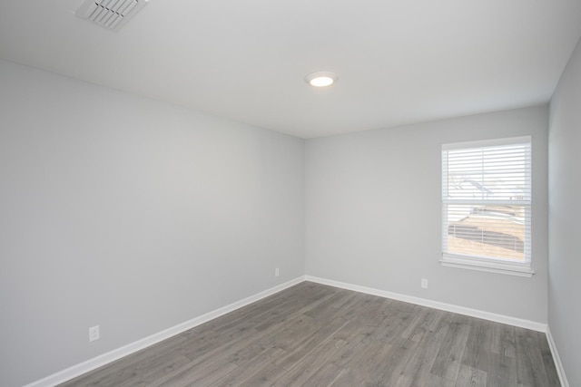 unfurnished room with wood-type flooring