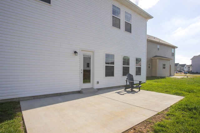 back of property featuring a patio area and a yard