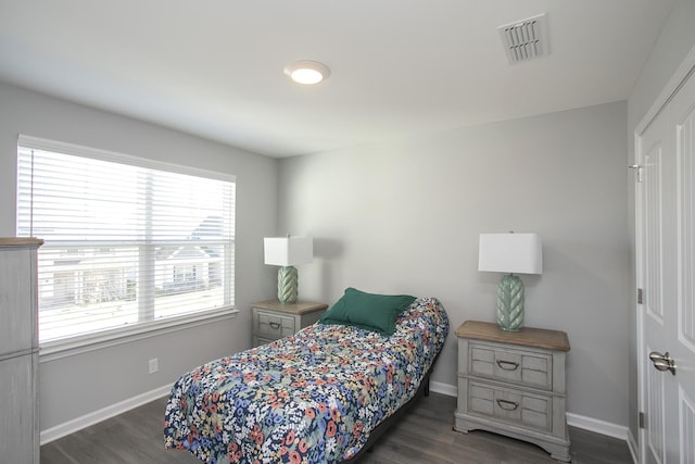 bedroom with dark wood-type flooring