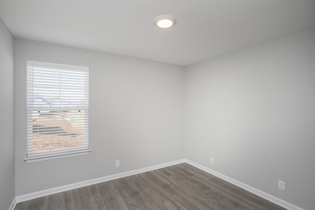 unfurnished room featuring dark wood-type flooring