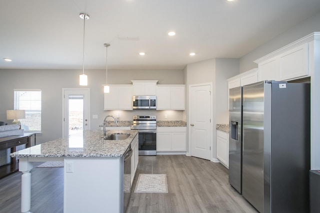 kitchen with white cabinetry, sink, pendant lighting, and appliances with stainless steel finishes