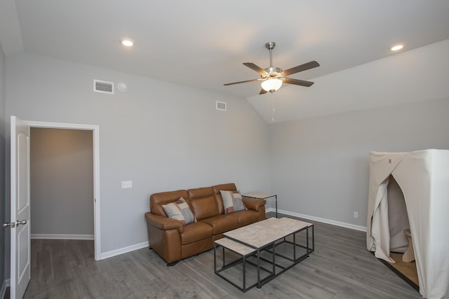 living room featuring hardwood / wood-style floors, ceiling fan, and vaulted ceiling