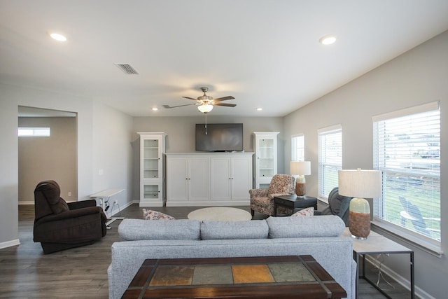 living room featuring ceiling fan and dark hardwood / wood-style flooring