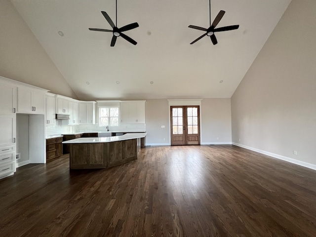 kitchen featuring a center island, high vaulted ceiling, french doors, white cabinets, and dark hardwood / wood-style flooring