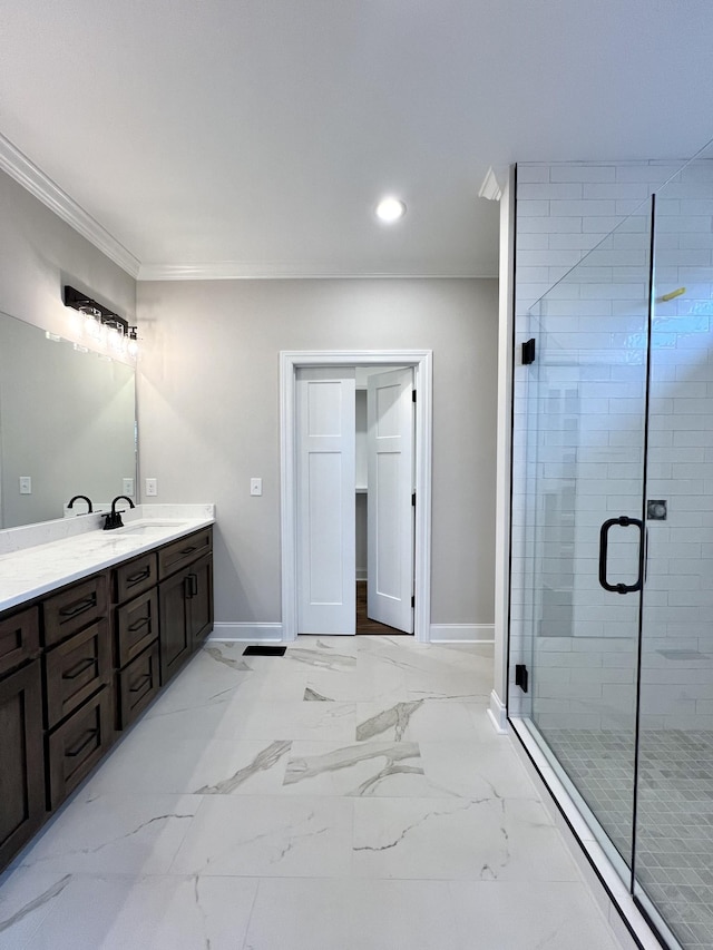 bathroom with vanity, an enclosed shower, and crown molding