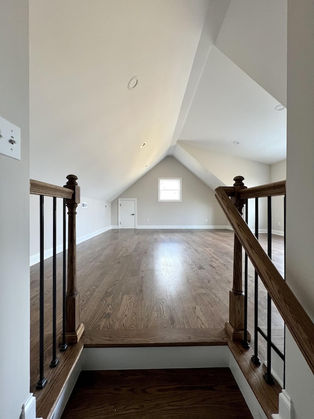 additional living space featuring hardwood / wood-style flooring and vaulted ceiling