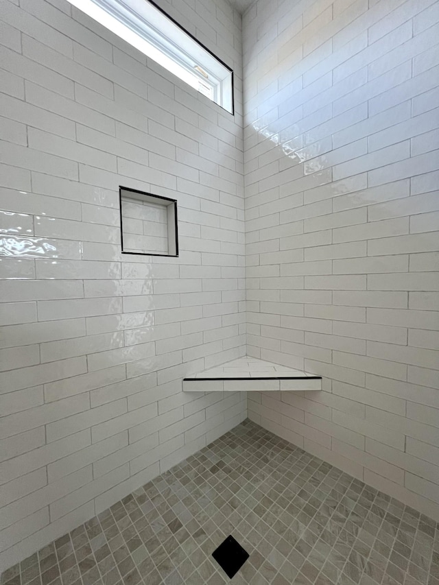 bathroom with a tile shower