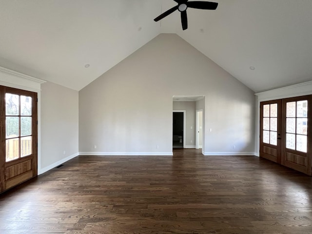 unfurnished living room with french doors, dark hardwood / wood-style floors, high vaulted ceiling, and plenty of natural light