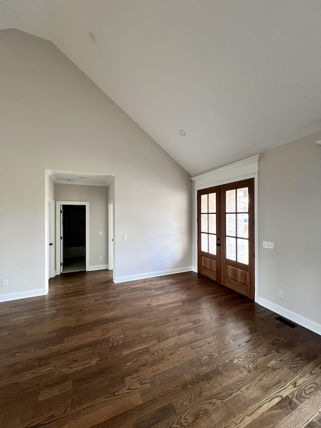 unfurnished room featuring vaulted ceiling, dark hardwood / wood-style flooring, and french doors