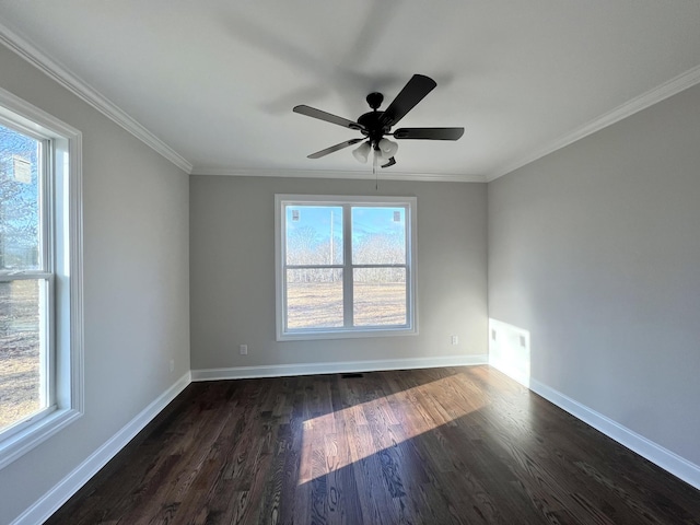 empty room featuring crown molding, a healthy amount of sunlight, and dark hardwood / wood-style floors