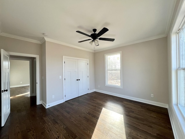 unfurnished bedroom with a closet, ceiling fan, dark hardwood / wood-style flooring, and crown molding