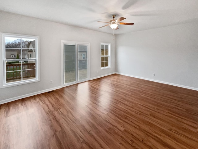 spare room featuring dark hardwood / wood-style flooring and ceiling fan