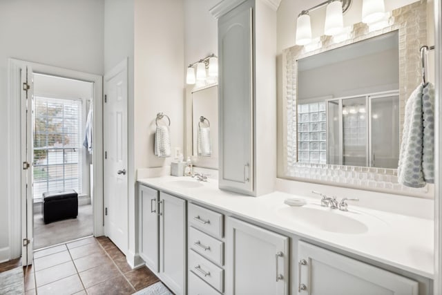 bathroom featuring tile patterned floors, vanity, and walk in shower