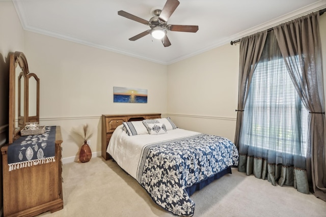 carpeted bedroom featuring ceiling fan and crown molding