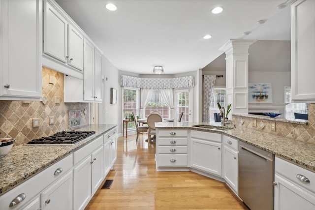 kitchen featuring white cabinets, light hardwood / wood-style floors, and appliances with stainless steel finishes