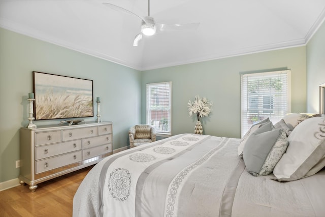 bedroom featuring ceiling fan, vaulted ceiling, crown molding, and light hardwood / wood-style flooring