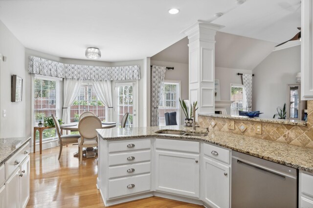 kitchen with sink, white cabinets, stainless steel dishwasher, and light hardwood / wood-style flooring